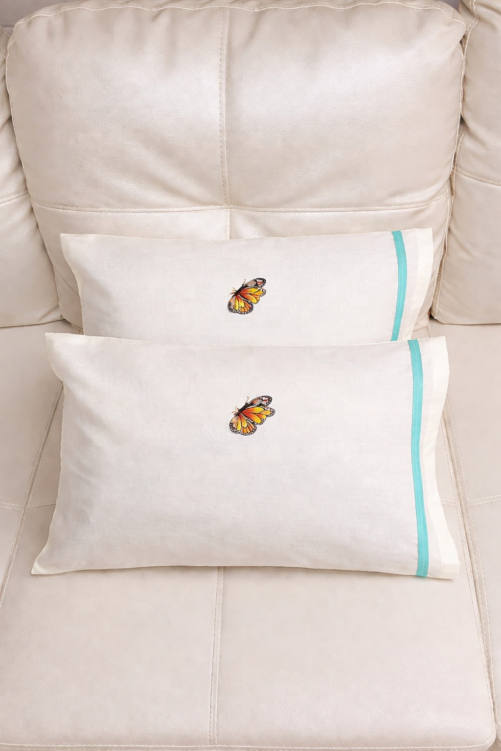 1 set of 2 small white pillocases with a small buttterfly printed detail. 