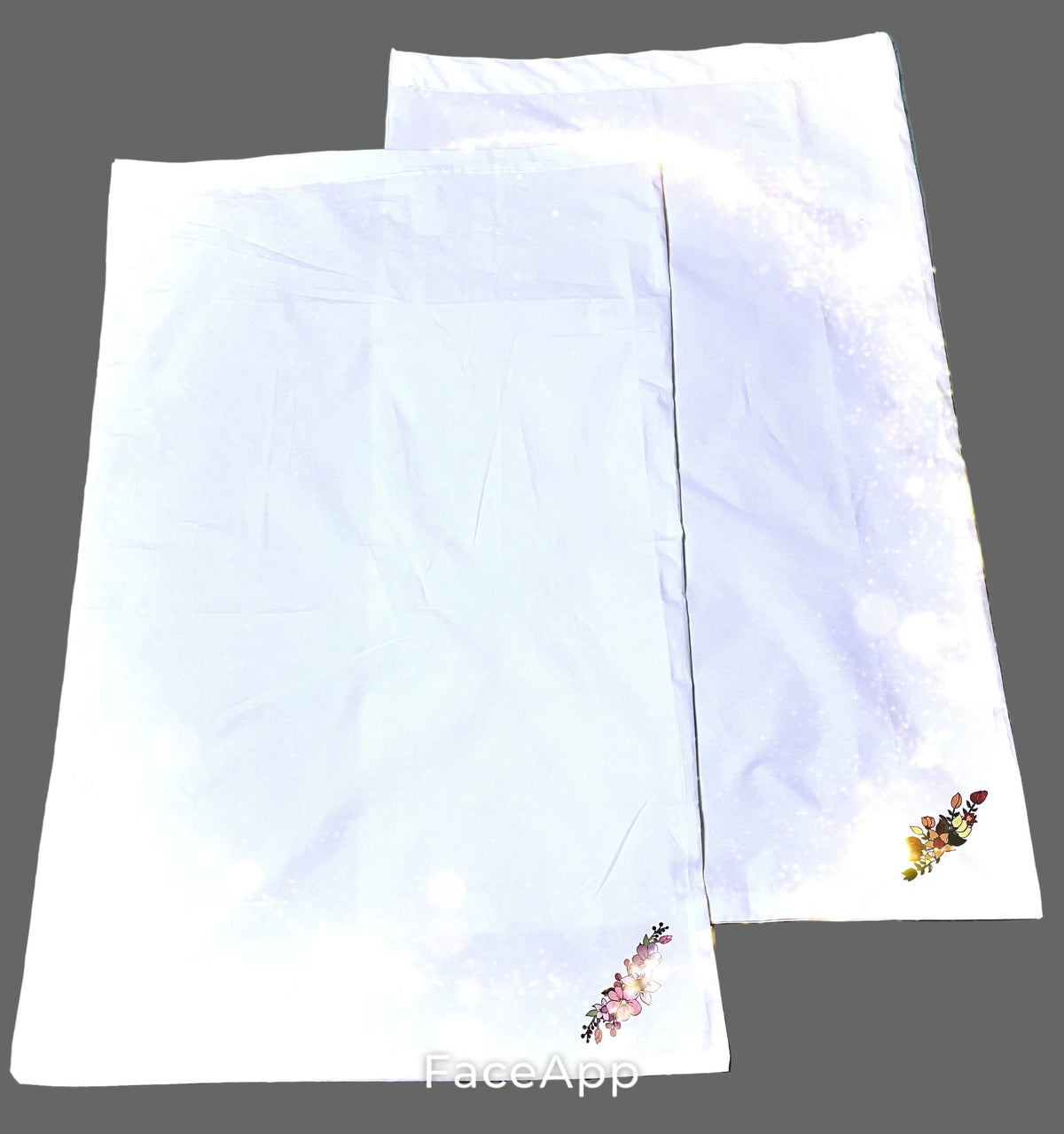 1 set of 2 standard, white cotton pillowcases with a small floral printed detail near the lower corners. 